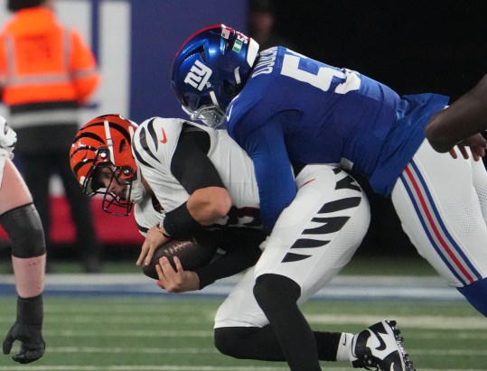 Oct 13, 2024; East Rutherford, New Jersey, USA;  New York Giants linebacker Azeez Ojulari (51) tackles Cincinnati Bengals quarterback Joe Burrow (9) during the first half at MetLife Stadium. Mandatory Credit: Robert Deutsch-Imagn Images