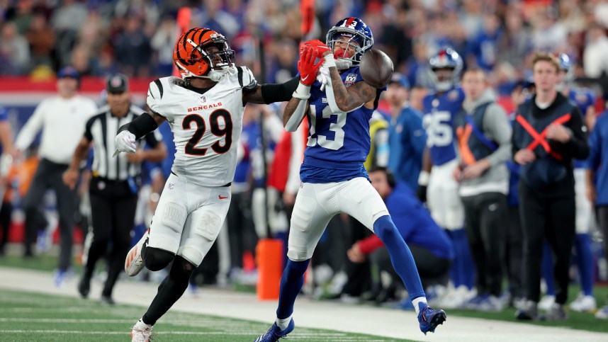 Oct 13, 2024; East Rutherford, New Jersey, USA; Cincinnati Bengals cornerback Cam Taylor-Britt (29) breaks up a pass intended for New York Giants wide receiver Jalin Hyatt (13) during the fourth quarter at MetLife Stadium. Mandatory Credit: Brad Penner-Imagn Images