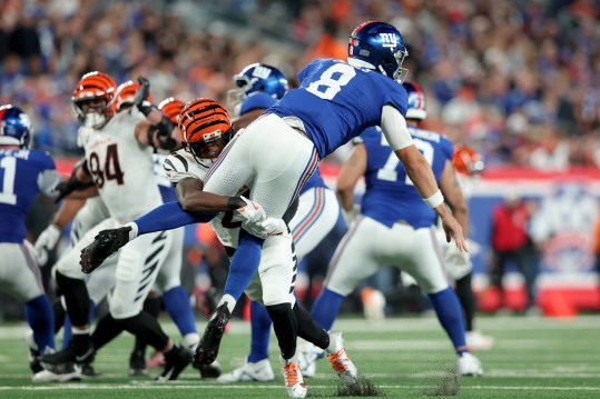 Oct 13, 2024; East Rutherford, New Jersey, USA; Cincinnati Bengals cornerback Mike Hilton (21) hits New York Giants quarterback Daniel Jones (8) after a pass during the third quarter at MetLife Stadium. Mandatory Credit: Brad Penner-Imagn Images