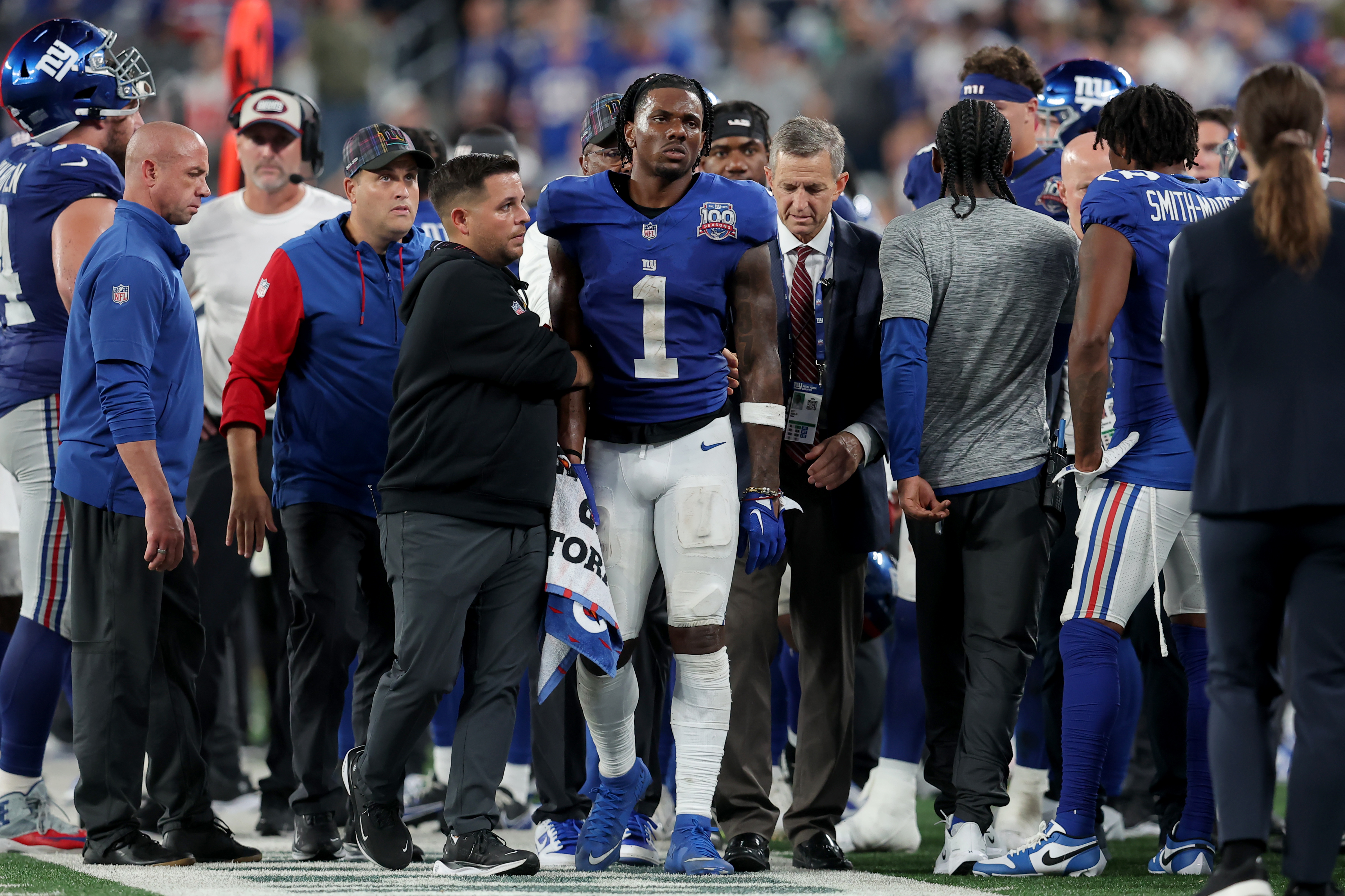 Sep 26, 2024; East Rutherford, New Jersey, USA; New York Giants wide receiver Malik Nabers (1) is helped off the field after an injury during the fourth quarter against the Dallas Cowboys at MetLife Stadium. Mandatory Credit: Brad Penner-Imagn Images