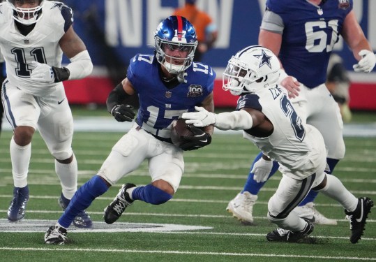 Sep 26, 2024; East Rutherford, New Jersey, USA;  New York Giants wide receiver Wan'Dale Robinson (17) runs past Dallas Cowboys cornerback Jourdan Lewis (2) during the second half at MetLife Stadium. Mandatory Credit: Robert Deutsch-Imagn Images