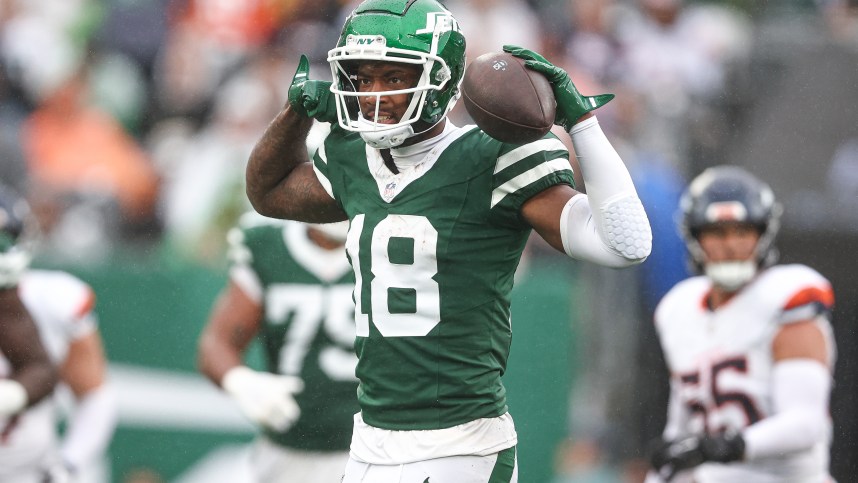 Sep 29, 2024; East Rutherford, New Jersey, USA; New York Jets wide receiver Mike Williams (18) celebrates a first down reception during the second half against the Denver Broncos at MetLife Stadium. Mandatory Credit: Vincent Carchietta-Imagn Images