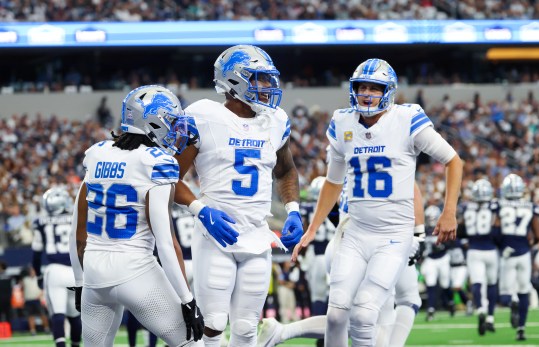 Oct 13, 2024; Arlington, Texas, USA; Detroit Lions running back David Montgomery (5) celebrates with Detroit Lions quarterback Jared Goff (16) and Detroit Lions running back Jahmyr Gibbs (26) after a touchdown during the first quarter against the Dallas Cowboys at AT&T Stadium. Mandatory Credit: Kevin Jairaj-Imagn Images