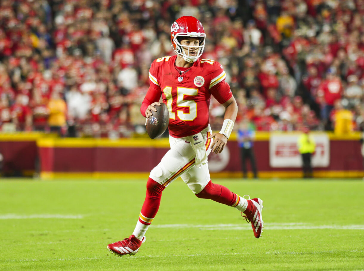 Oct 7, 2024; Kansas City, Missouri, USA; Kansas City Chiefs quarterback Patrick Mahomes (15) rolls out to pass during the first half against the New Orleans Saints at GEHA Field at Arrowhead Stadium. Mandatory Credit: Jay Biggerstaff-Imagn Images