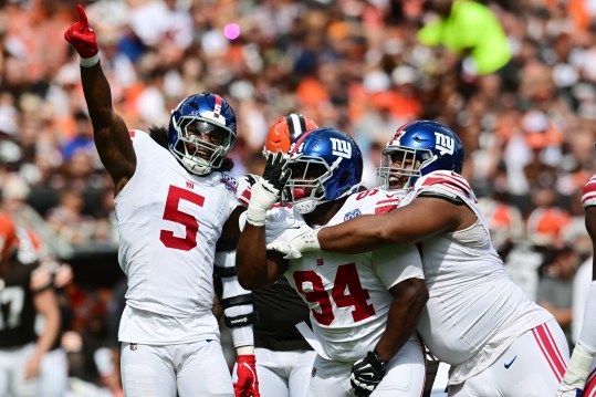 Sep 22, 2024; Cleveland, Ohio, USA; New York Giants linebacker Kayvon Thibodeaux (5) and defensive tackle Elijah Chatman (94) and defensive tackle Dexter Lawrence II (97) celebrate after sacking Cleveland Browns quarterback Deshaun Watson (not pictured) during the first quarter at Huntington Bank Field. Mandatory Credit: Ken Blaze-Imagn Images