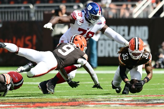 Sep 22, 2024; Cleveland, Ohio, USA; Cleveland Browns safety Ronnie Hickman (33) recovers a fumble in front of New York Giants offensive tackle Andrew Thomas (78) during the second half at Huntington Bank Field. Mandatory Credit: Ken Blaze-Imagn Images