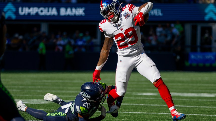 Oct 6, 2024; Seattle, Washington, USA; New York Giants running back Tyrone Tracy Jr. (29) breaks a tackle attempt by Seattle Seahawks safety Julian Love (20) during the second quarter at Lumen Field. Mandatory Credit: Joe Nicholson-Imagn Images