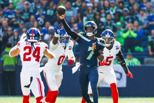 Oct 6, 2024; Seattle, Washington, USA; Seattle Seahawks quarterback Geno Smith (7) passes against New York Giants linebacker Brian Burns (0) and linebacker Kayvon Thibodeaux (5) during the second quarter at Lumen Field. Mandatory Credit: Joe Nicholson-Imagn Images