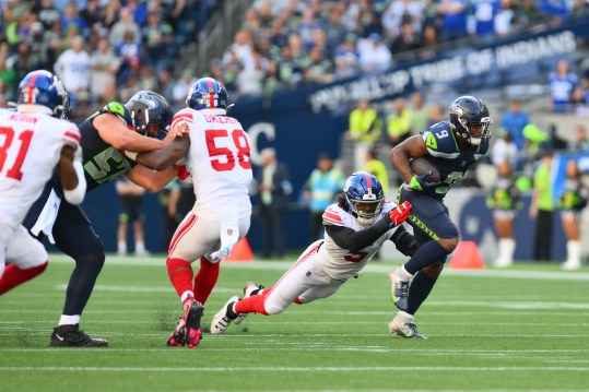 Oct 6, 2024; Seattle, Washington, USA; New York Giants linebacker Kayvon Thibodeaux (5) tackles Seattle Seahawks running back Kenneth Walker III (9) during the second half at Lumen Field. Mandatory Credit: Steven Bisig-Imagn Images