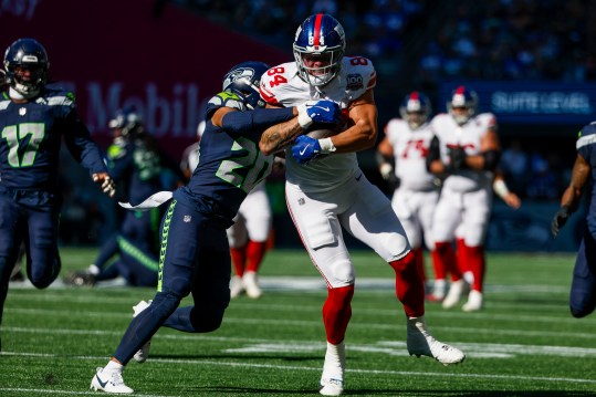 Oct 6, 2024; Seattle, Washington, USA; New York Giants tight end Theo Johnson (84) runs for yards after the catch against Seattle Seahawks safety Julian Love (20) during the second quarter at Lumen Field. Mandatory Credit: Joe Nicholson-Imagn Images