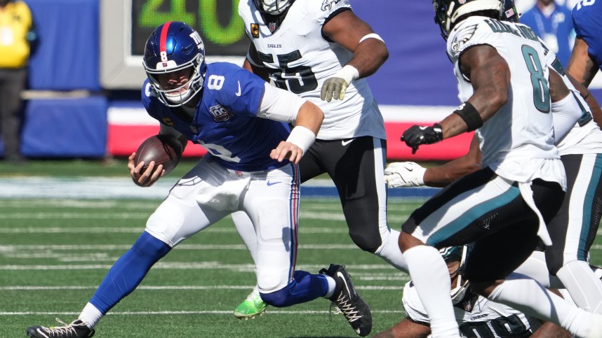 Oct 20, 2024; East Rutherford, New Jersey, USA;  New York Giants quarterback Daniel Jones (8) runs against the Philadelphia Eagles during the first half at MetLife Stadium. Mandatory Credit: Robert Deutsch-Imagn Images