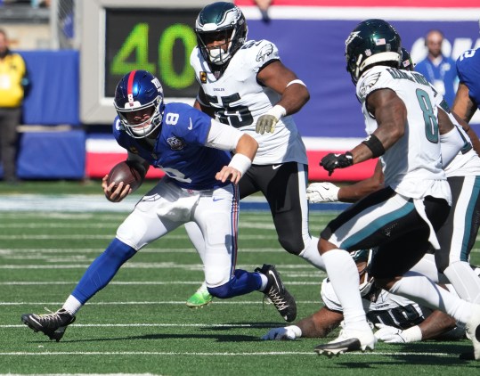 Oct 20, 2024; East Rutherford, New Jersey, USA;  New York Giants quarterback Daniel Jones (8) runs against the Philadelphia Eagles during the first half at MetLife Stadium. Mandatory Credit: Robert Deutsch-Imagn Images