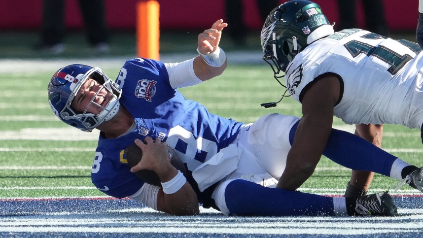 Oct 20, 2024; East Rutherford, New Jersey, USA;  New York Giants quarterback Daniel Jones (8) sacked by Philadelphia Eagles linebacker Nakobe Dean (17) during the second half at MetLife Stadium. Mandatory Credit: Robert Deutsch-Imagn Images