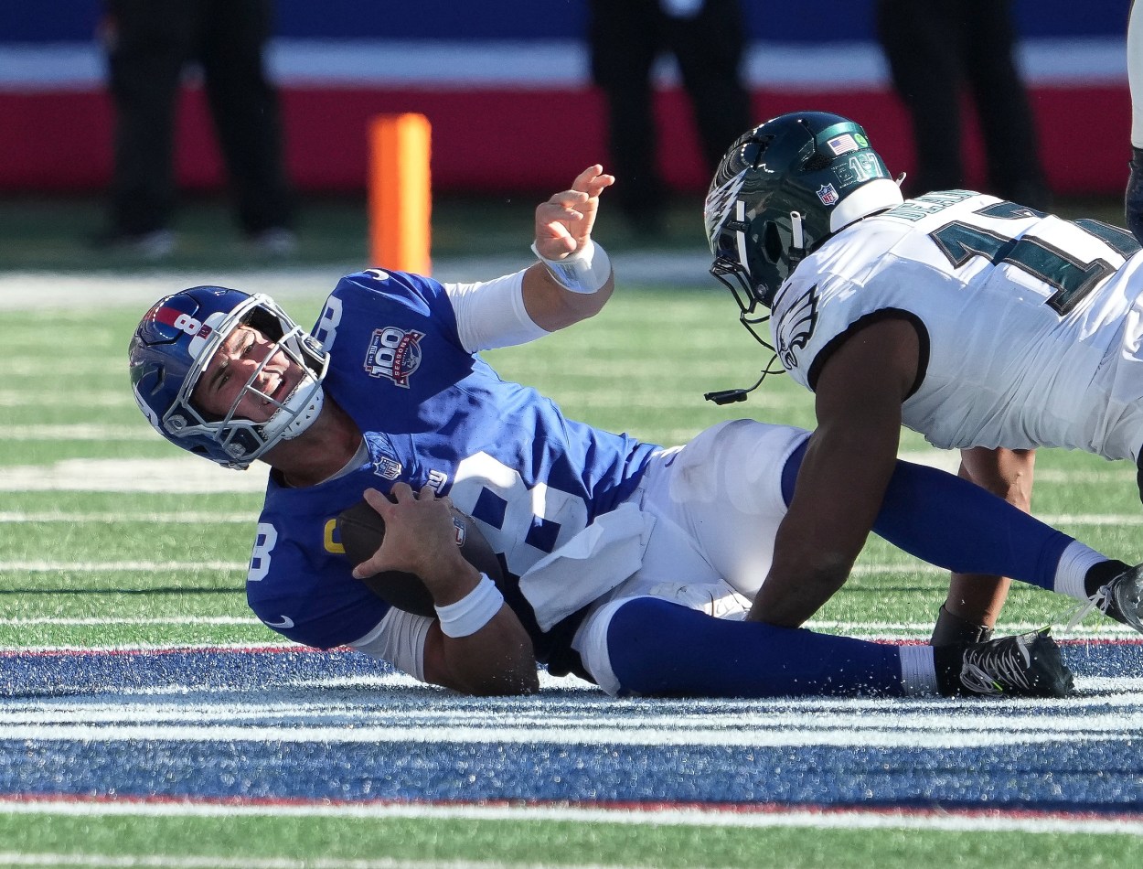 Oct 20, 2024; East Rutherford, New Jersey, USA;  New York Giants quarterback Daniel Jones (8) sacked by Philadelphia Eagles linebacker Nakobe Dean (17) during the second half at MetLife Stadium. Mandatory Credit: Robert Deutsch-Imagn Images