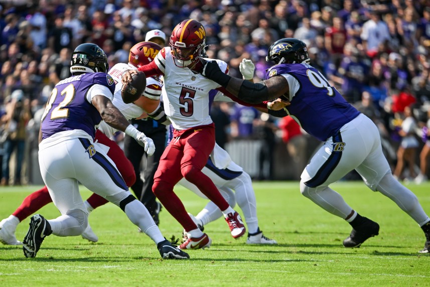 Oct 13, 2024; Baltimore, Maryland, USA;  Baltimore Ravens defensive tackle Travis Jones (98) sacks Washington Commanders quarterback Jayden Daniels (5) during the first quarter at M&T Bank Stadium. Mandatory Credit: Tommy Gilligan-Imagn Images