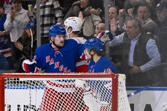 Oct 14, 2024; New York, New York, USA;  New York Rangers left wing Alexis Lafrenière (13) celebrates his goal with New York Rangers left wing Artemi Panarin (10) against the Detroit Red Wings during the first period at Madison Square Garden. Mandatory Credit: Dennis Schneidler-Imagn Images