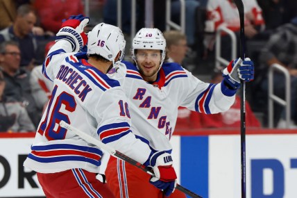 Oct 17, 2024; Detroit, Michigan, USA;  New York Rangers left wing Artemi Panarin (10) receives congratulations from teammates after scoring in the first period against the Detroit Red Wings at Little Caesars Arena. Mandatory Credit: Rick Osentoski-Imagn Images