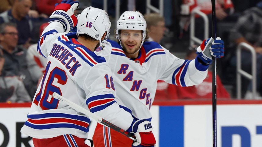 Oct 17, 2024; Detroit, Michigan, USA;  New York Rangers left wing Artemi Panarin (10) receives congratulations from teammates after scoring in the first period against the Detroit Red Wings at Little Caesars Arena. Mandatory Credit: Rick Osentoski-Imagn Images