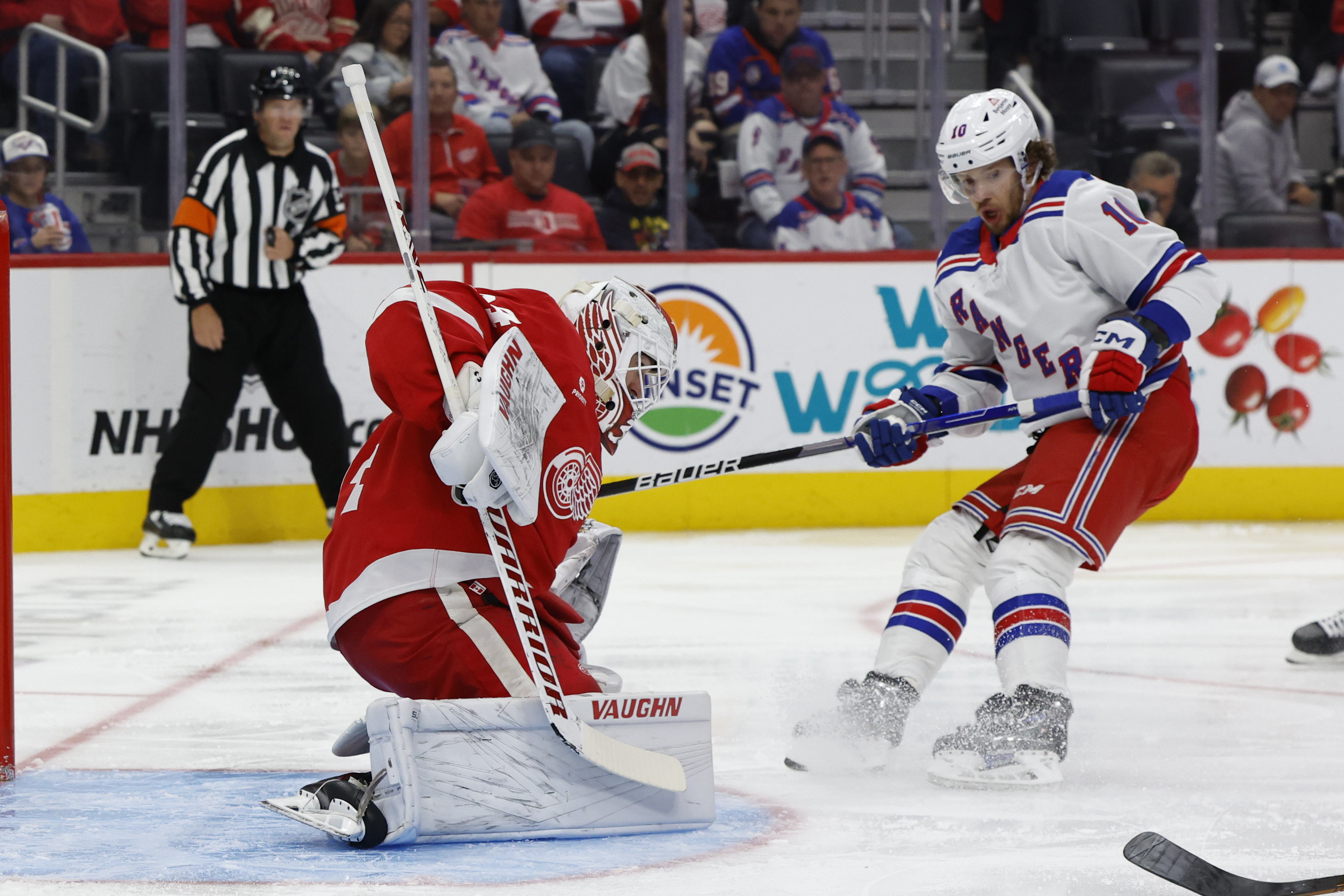 Oct 17, 2024; Detroit, Michigan, USA;  Detroit Red Wings goaltender Alex Lyon (34) makes a save on New York Rangers left wing Artemi Panarin (10) in the third period at Little Caesars Arena. Mandatory Credit: Rick Osentoski-Imagn Images