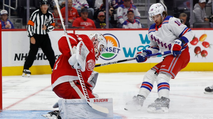 Oct 17, 2024; Detroit, Michigan, USA;  Detroit Red Wings goaltender Alex Lyon (34) makes a save on New York Rangers left wing Artemi Panarin (10) in the third period at Little Caesars Arena. Mandatory Credit: Rick Osentoski-Imagn Images