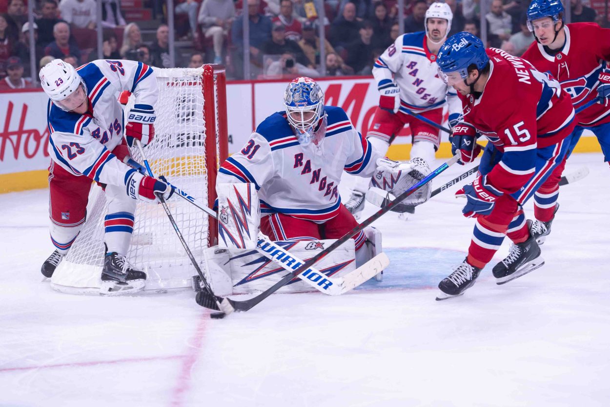 Oct 22, 2024; Ottawa, Ontario, CAN; New York Rangers defenseman Adam Fox (23) battles with Montreal Canadiens center Alex Newhook (15) for control of the puck in the second period at the Bell Centre. Mandatory Credit: Marc DesRosiers-Imagn Images