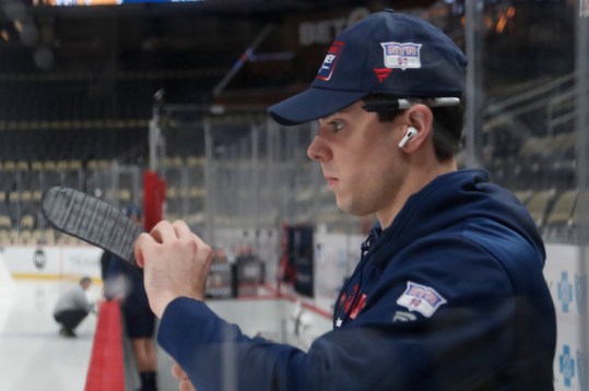 Oct 9, 2024; Pittsburgh, Pennsylvania, USA;  New York Rangers defenseman Victor Mancini (90) prepares his stick before making his NHL debut against the Pittsburgh Penguins at PPG Paints Arena. Mandatory Credit: Charles LeClaire-Imagn Images