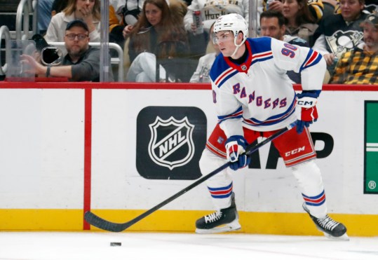 Oct 9, 2024; Pittsburgh, Pennsylvania, USA;  New York Rangers defenseman Victor Mancini (90) handles the puck the Pittsburgh Penguins during the third period against at PPG Paints Arena. Mandatory Credit: Charles LeClaire-Imagn Images