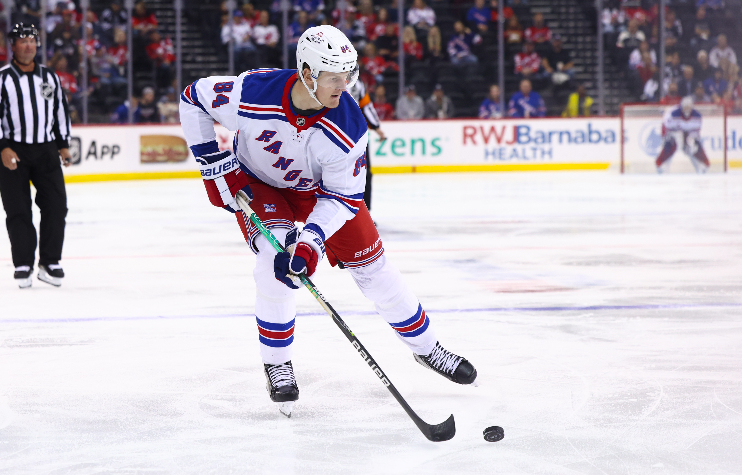 Sep 30, 2024; Newark, New Jersey, USA; New York Rangers center Adam Edstrom (84) skates with the puck against the New Jersey Devils during the first period at Prudential Center. Mandatory Credit: Ed Mulholland-Imagn Images