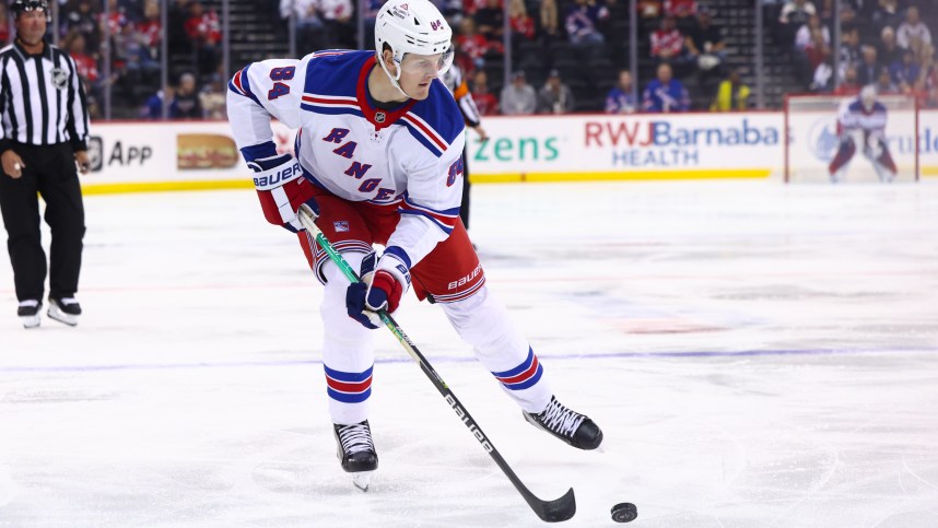 Sep 30, 2024; Newark, New Jersey, USA; New York Rangers center Adam Edstrom (84) skates with the puck against the New Jersey Devils during the first period at Prudential Center. Mandatory Credit: Ed Mulholland-Imagn Images