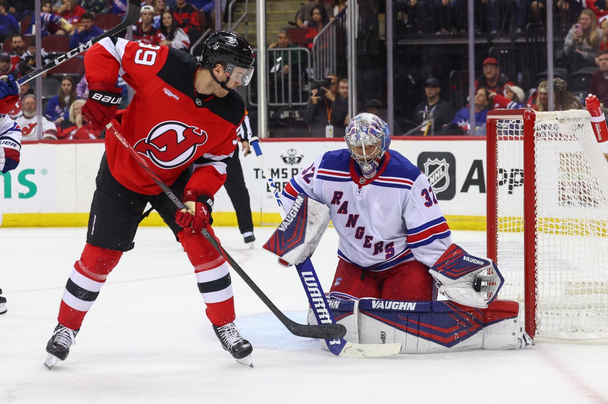 Sep 30, 2024; Newark, New Jersey, USA; New York Rangers goaltender Jonathan Quick (32) makes a save against New Jersey Devils left wing Mike Hardman (39) during the second period at Prudential Center. Mandatory Credit: Ed Mulholland-Imagn Images