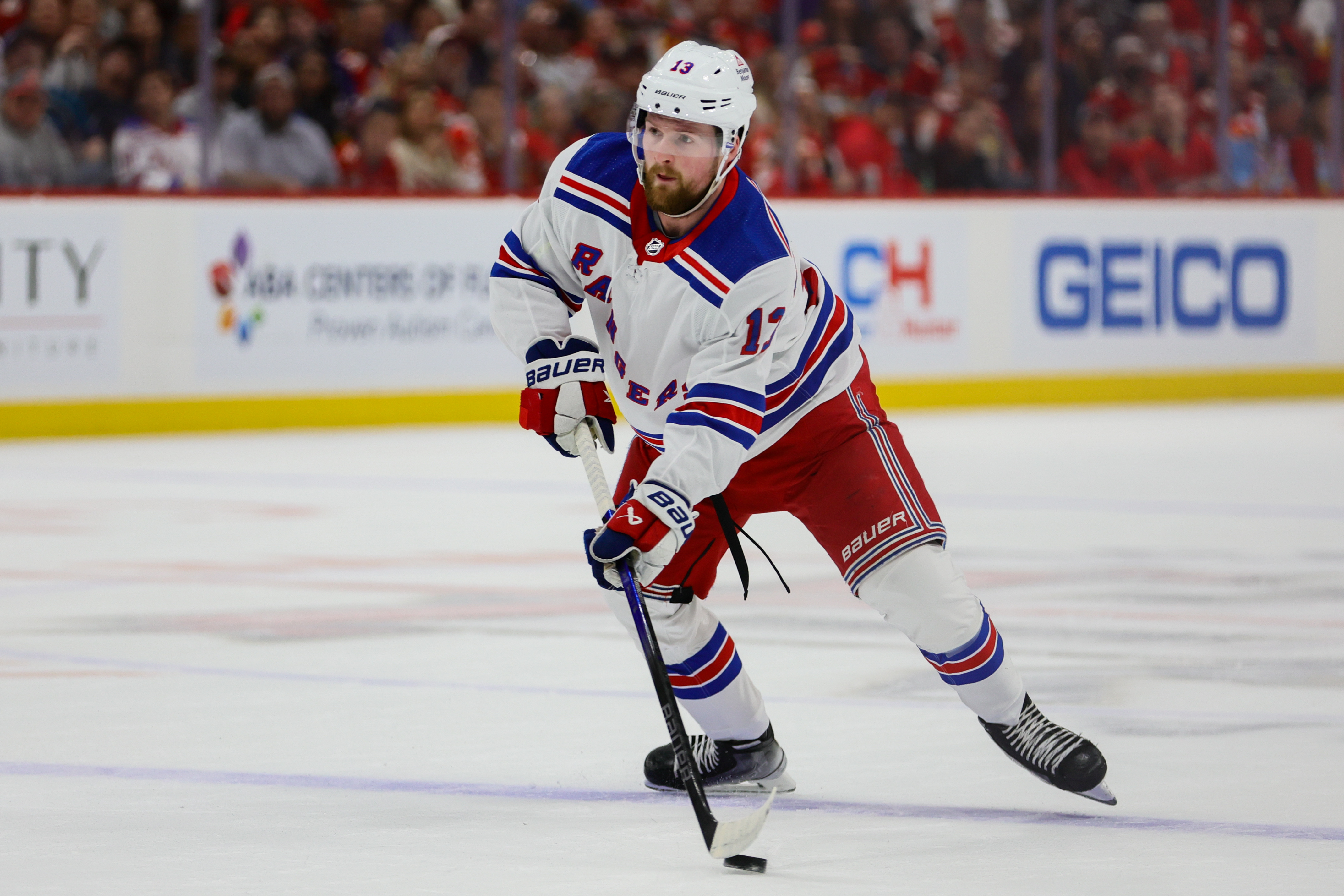 May 28, 2024; Sunrise, Florida, USA; New York Rangers left wing Alexis Lafreniere (13) moves the puck against the Florida Panthers during the first period in game four of the Eastern Conference Final of the 2024 Stanley Cup Playoffs at Amerant Bank Arena. Mandatory Credit: Sam Navarro-Imagn Images