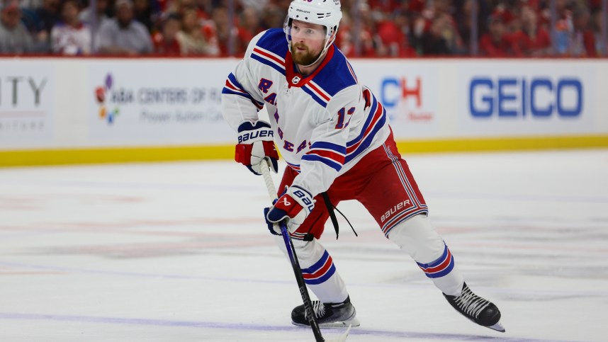 May 28, 2024; Sunrise, Florida, USA; New York Rangers left wing Alexis Lafreniere (13) moves the puck against the Florida Panthers during the first period in game four of the Eastern Conference Final of the 2024 Stanley Cup Playoffs at Amerant Bank Arena. Mandatory Credit: Sam Navarro-Imagn Images