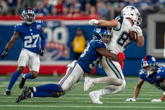 Sep 26, 2024; East Rutherford, NJ, US; Dallas Cowboys tight end Jake Ferguson (87) is taken down after catching a pass by New York Giants linebacker Bobby Okereke (58) at MetLife Stadium. Mandatory Credit: Julian Guadalupe-NorthJersey.com