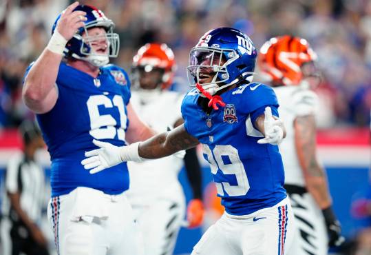 New York Giants running back Tyrone Tracy Jr. (29) celebrates his third quarter touchdown beside teammate New York Giants center John Michael Schmitz Jr. (61), Sunday, October 13, 2024, in East Rutherford.