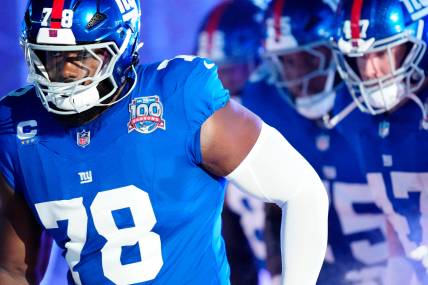 New York Giants offensive tackle Andrew Thomas (78) and his teammates run onto the field moments before kickoff, Sunday, October 13, 2024, in East Rutherford.