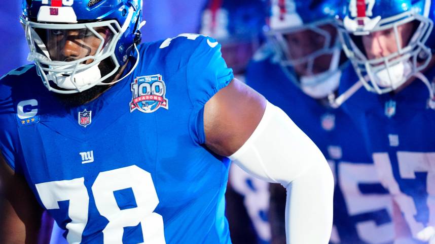 New York Giants offensive tackle Andrew Thomas (78) and his teammates run onto the field moments before kickoff, Sunday, October 13, 2024, in East Rutherford.