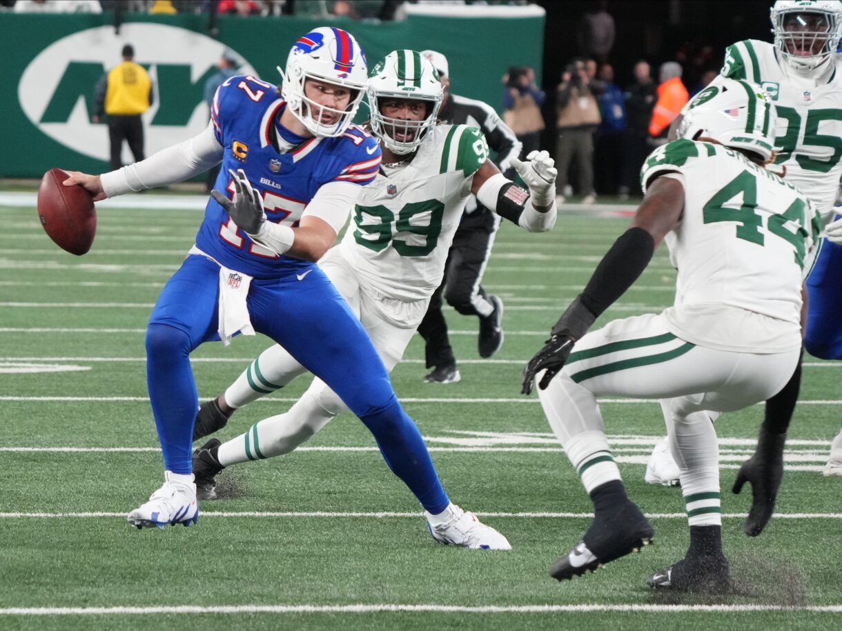 East Rutherford, NJ -- October 14, 2024 -- Josh Allen of Buffalo tries to avoid Jamien Sherwood of the Jets in the first half. The Buffalo Bills came to MetLife Stadium to play the NY Jets. The Jets played their first game under new interim head coach Jeff Ulbrich.