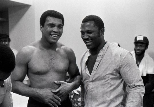 Sep 13, 1978; New Orleans, LA, USA; FILE PHOTO; Muhammad Ali (left) shares a laugh with Joe Frazier (right) in his training room during his training for his bout with Leon Spinks (not pictured) at the Superdome. Mandatory Credit: Keith Williams/The Courier-Journal-Imagn Images