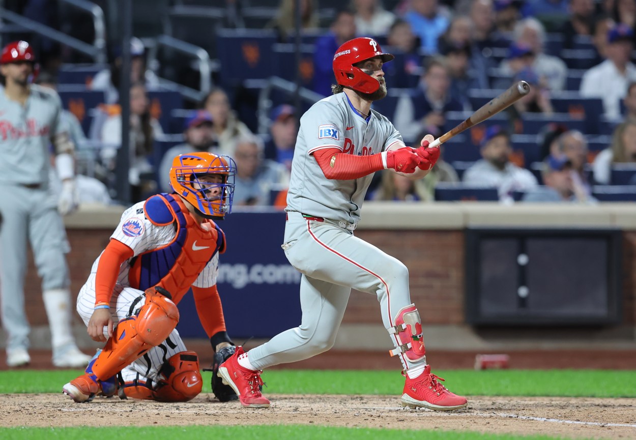 Oct 9, 2024; New York, New York, USA; Philadelphia Phillies first baseman Bryce Harper (3) hits a double in the sixth inning against the New York Mets in game four of the NLDS for the 2024 MLB Playoffs at Citi Field. Mandatory Credit: Brad Penner-Imagn Images