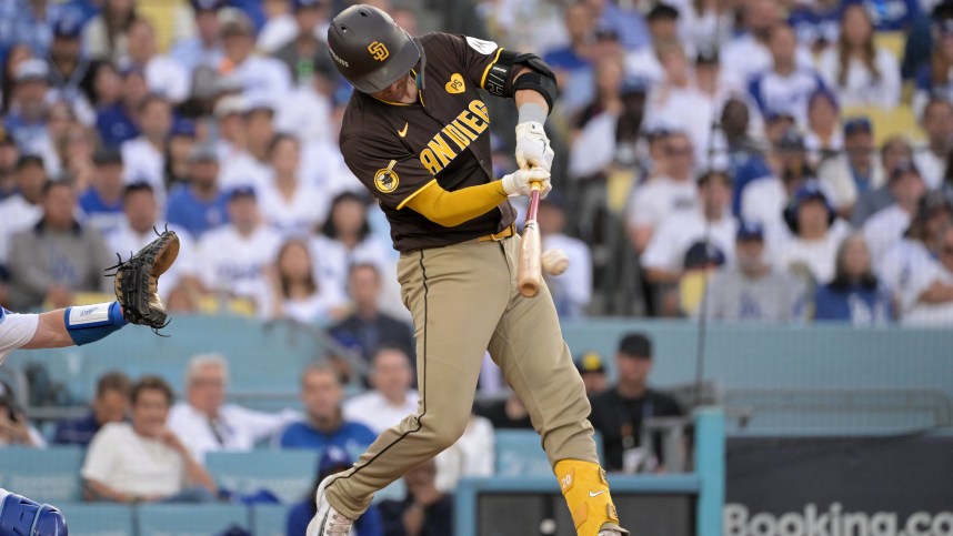 Oct 11, 2024; Los Angeles, California, USA; San Diego Padres catcher Kyle Higashioka (20) hits a single in the third inning against the Los Angeles Dodgers during game five of the NLDS for the 2024 MLB Playoffs at Dodger Stadium. Mandatory Credit: Jayne Kamin-Oncea-Imagn Images