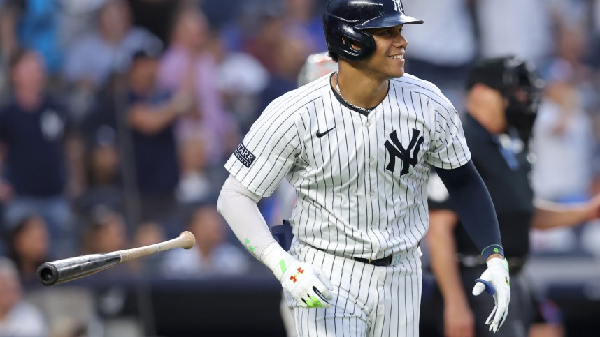 Jul 24, 2024; Bronx, New York, USA; New York Yankees right fielder Juan Soto (22) flips his bat after hitting a solo home run against the New York Mets during the third inning at Yankee Stadium. Mandatory Credit: Brad Penner-Imagn Images