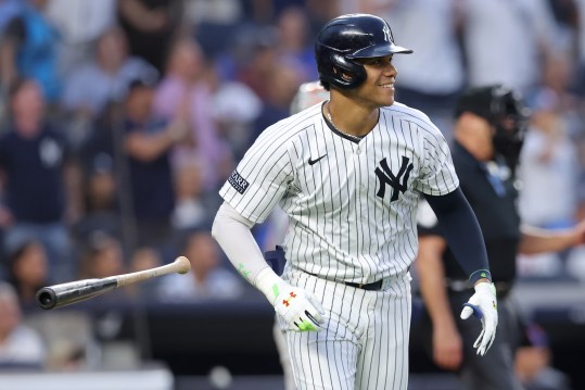 Jul 24, 2024; Bronx, New York, USA; New York Yankees right fielder Juan Soto (22) flips his bat after hitting a solo home run against the New York Mets during the third inning at Yankee Stadium. Mandatory Credit: Brad Penner-Imagn Images