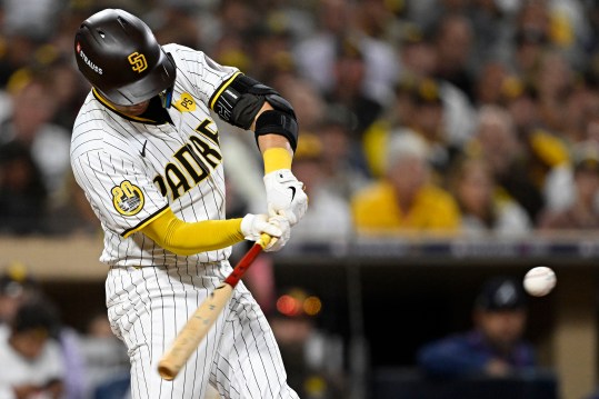 Oct 1, 2024; San Diego, California, USA; San Diego Padres catcher Kyle Higashioka (20) hits a solo home run against the Atlanta Braves during the eighth inning in game one of the Wildcard round for the 2024 MLB Playoffs at Petco Park. Mandatory Credit: Denis Poroy-Imagn Images