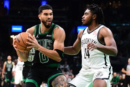 Nov 8, 2024; Boston, Massachusetts, USA;  Boston Celtics forward Jayson Tatum (0) controls the ball while Brooklyn Nets guard Cam Thomas (24) defends during the second half at TD Garden. Mandatory Credit: Bob DeChiara-Imagn Images