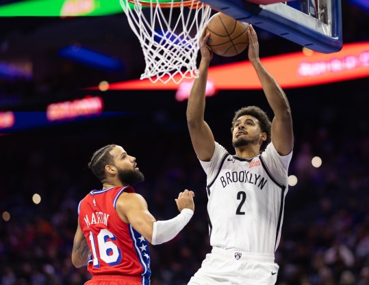 Nov 22, 2024; Philadelphia, Pennsylvania, USA; Brooklyn Nets forward Cameron Johnson (2) drives for a shot past Philadelphia 76ers forward Caleb Martin (16) during the first quarter at Wells Fargo Center. Mandatory Credit: Bill Streicher-Imagn Images