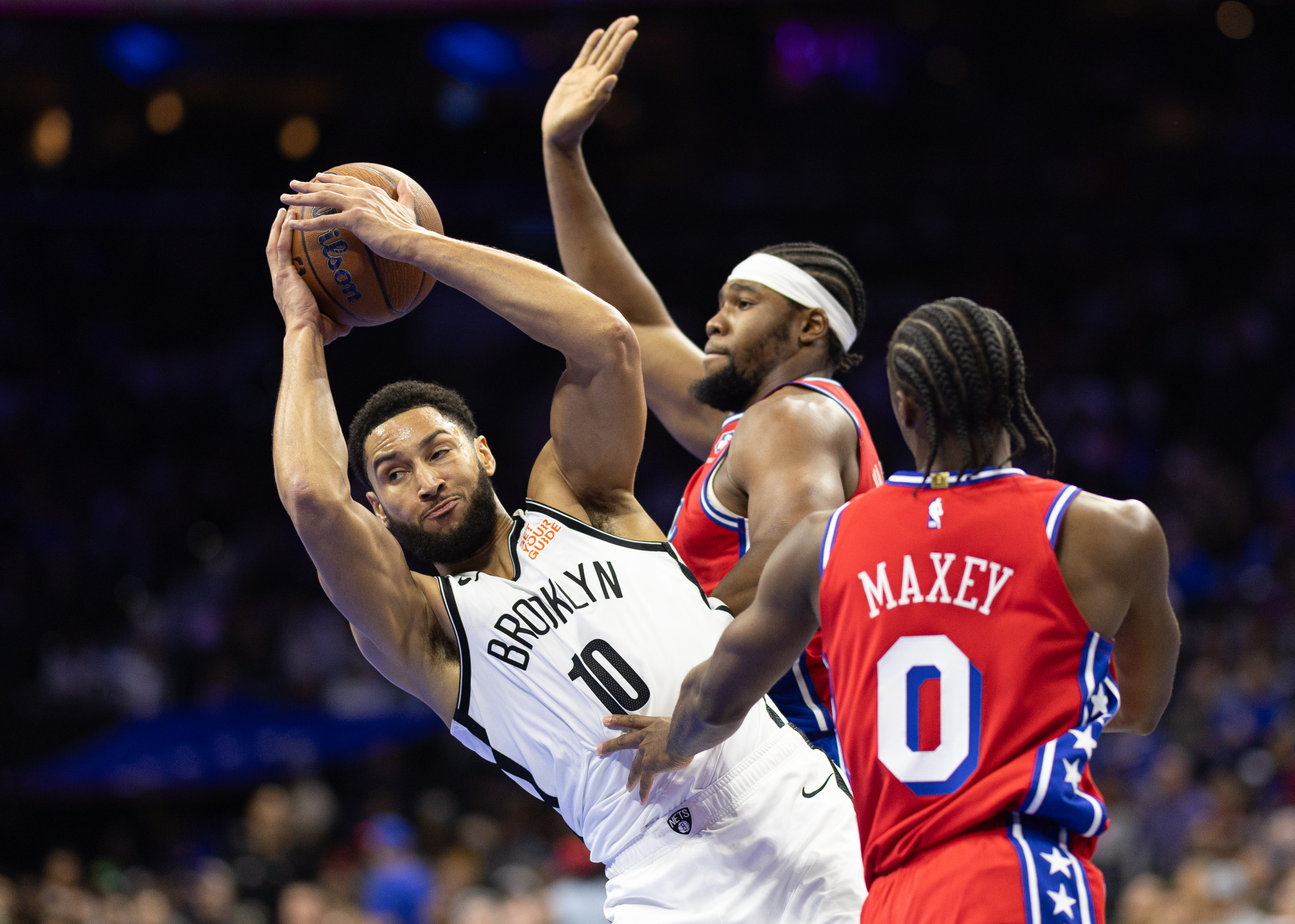 Nov 22, 2024; Philadelphia, Pennsylvania, USA; Brooklyn Nets guard Ben Simmons (10) controls the ball against Philadelphia 76ers guard Tyrese Maxey (0) and forward Guerschon Yabusele (28) during the second quarter at Wells Fargo Center. Mandatory Credit: Bill Streicher-Imagn Images