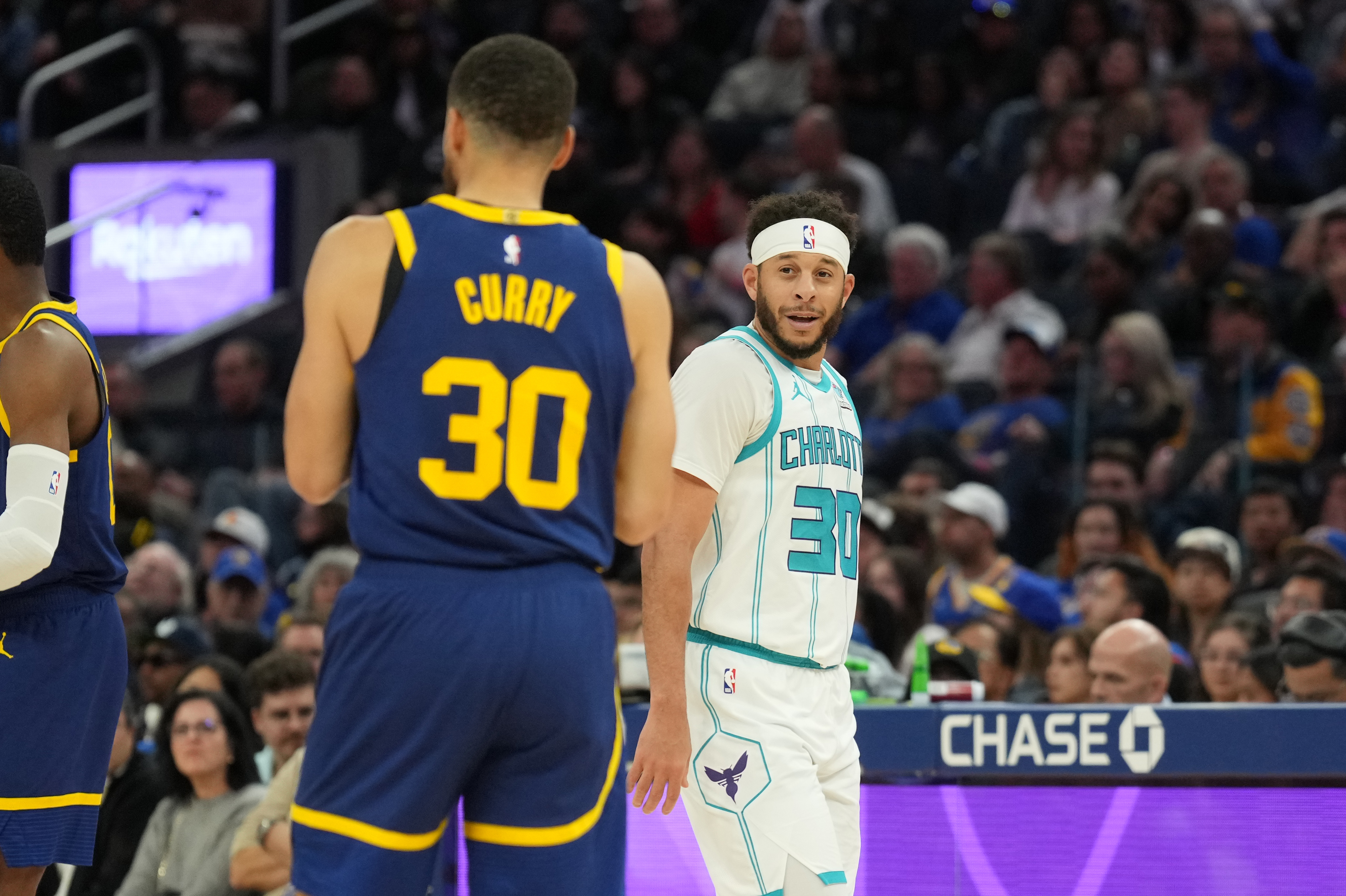 Feb 23, 2024; San Francisco, California, USA; Charlotte Hornets guard Seth Curry (right) talks with Golden State Warriors guard Stephen Curry (left) during the fourth quarter at Chase Center. Mandatory Credit: Darren Yamashita-Imagn Images