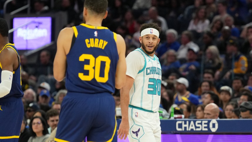 Feb 23, 2024; San Francisco, California, USA; Charlotte Hornets guard Seth Curry (right) talks with Golden State Warriors guard Stephen Curry (left) during the fourth quarter at Chase Center. Mandatory Credit: Darren Yamashita-Imagn Images