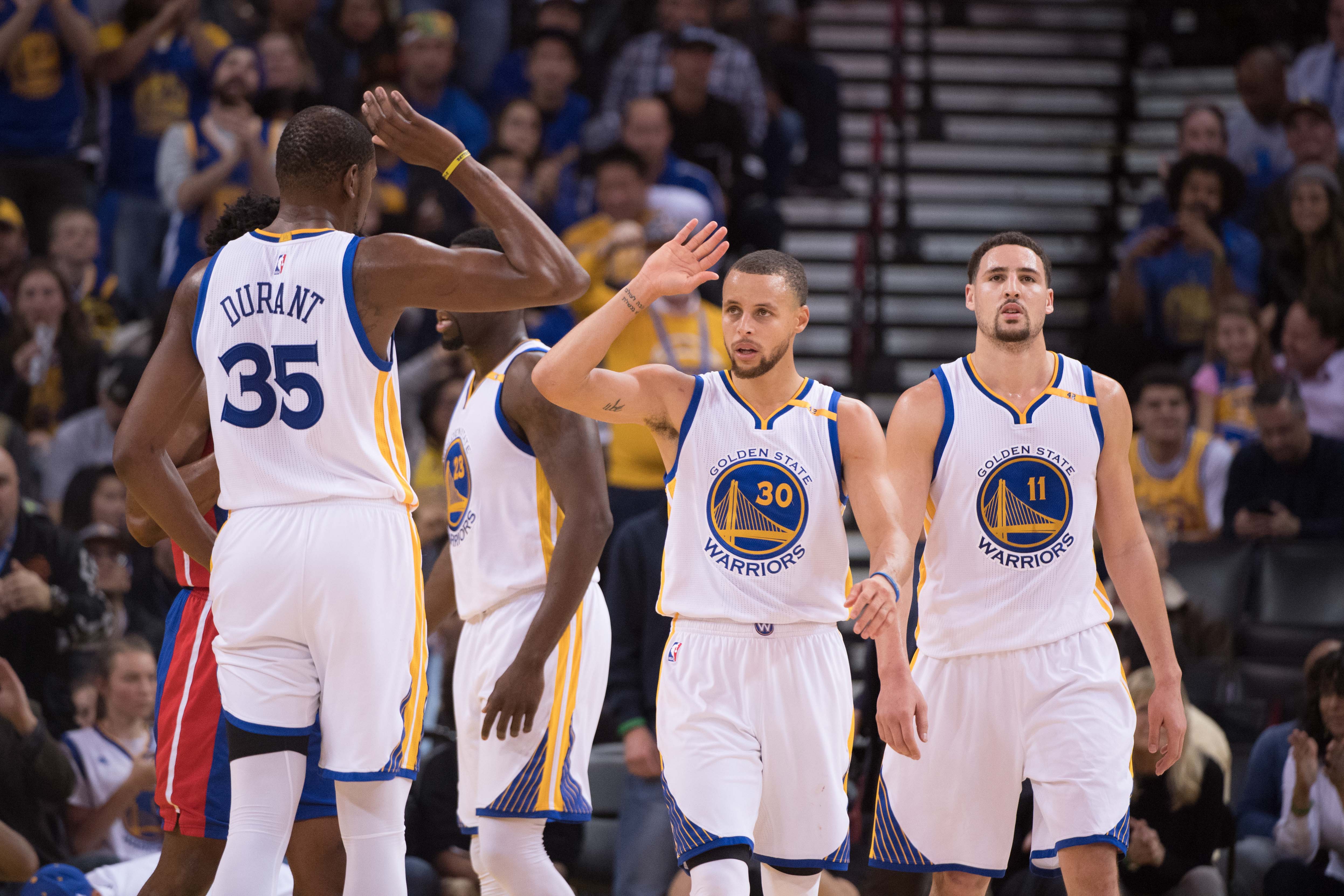 January 12, 2017; Oakland, CA, USA; Golden State Warriors forward Kevin Durant (35), guard Stephen Curry (30), and guard Klay Thompson (11) during the second quarter against the Detroit Pistons at Oracle Arena. The Warriors defeated the Pistons 127-107. Mandatory Credit: Kyle Terada-Imagn Images