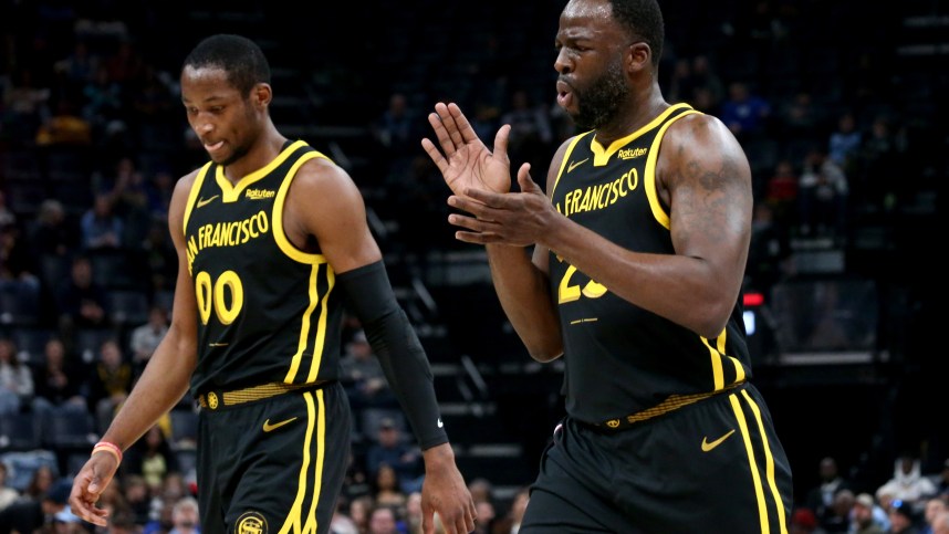 Jan 15, 2024; Memphis, Tennessee, USA; Golden State Warriors forward Jonathan Kuminga (00) and Golden State Warriors forward Draymond Green (23) walk to the bench at the end of the first quarter against the Memphis Grizzlies  at FedExForum. Mandatory Credit: Petre Thomas-Imagn Images